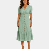 Lightweight shirt dress in light green, short sleeves, button front, tiered skirt hem.