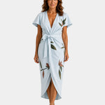 Light blue wrap dress with short sleeves, floral print, tied waist and midi length