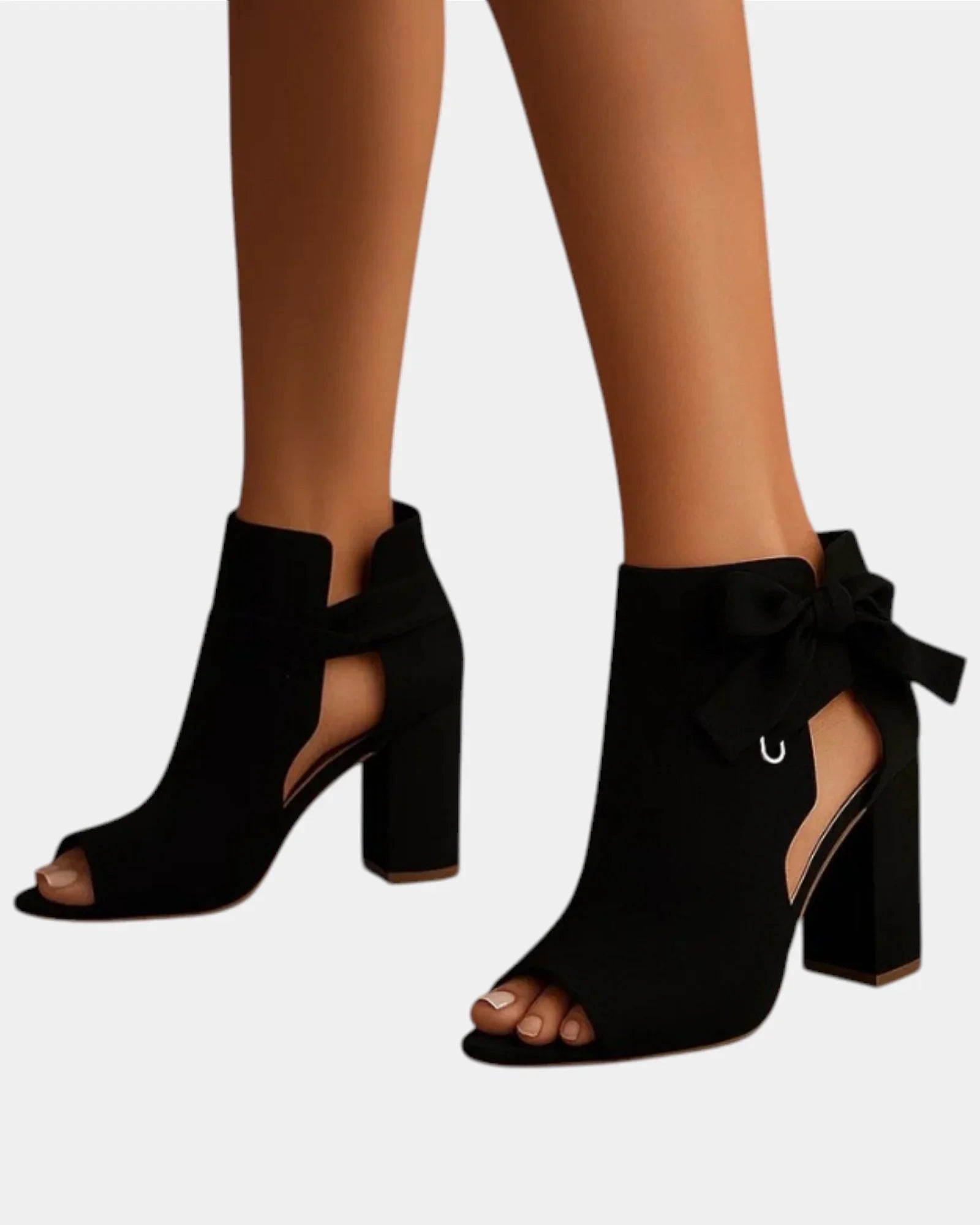 Black heeled sandals with peep toe, ankle bow, and block heel