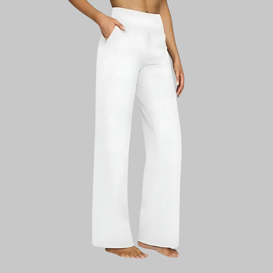White wide-leg pants with high-rise waistband and side pockets, straight relaxed fit.