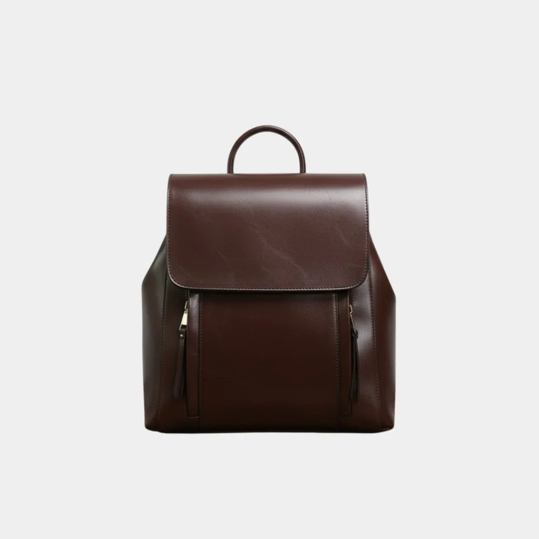 Dark brown leather backpack with top flap, handle loop, and two front zip pockets