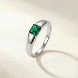Silver-tone ring with a square green gemstone set on a tapered band