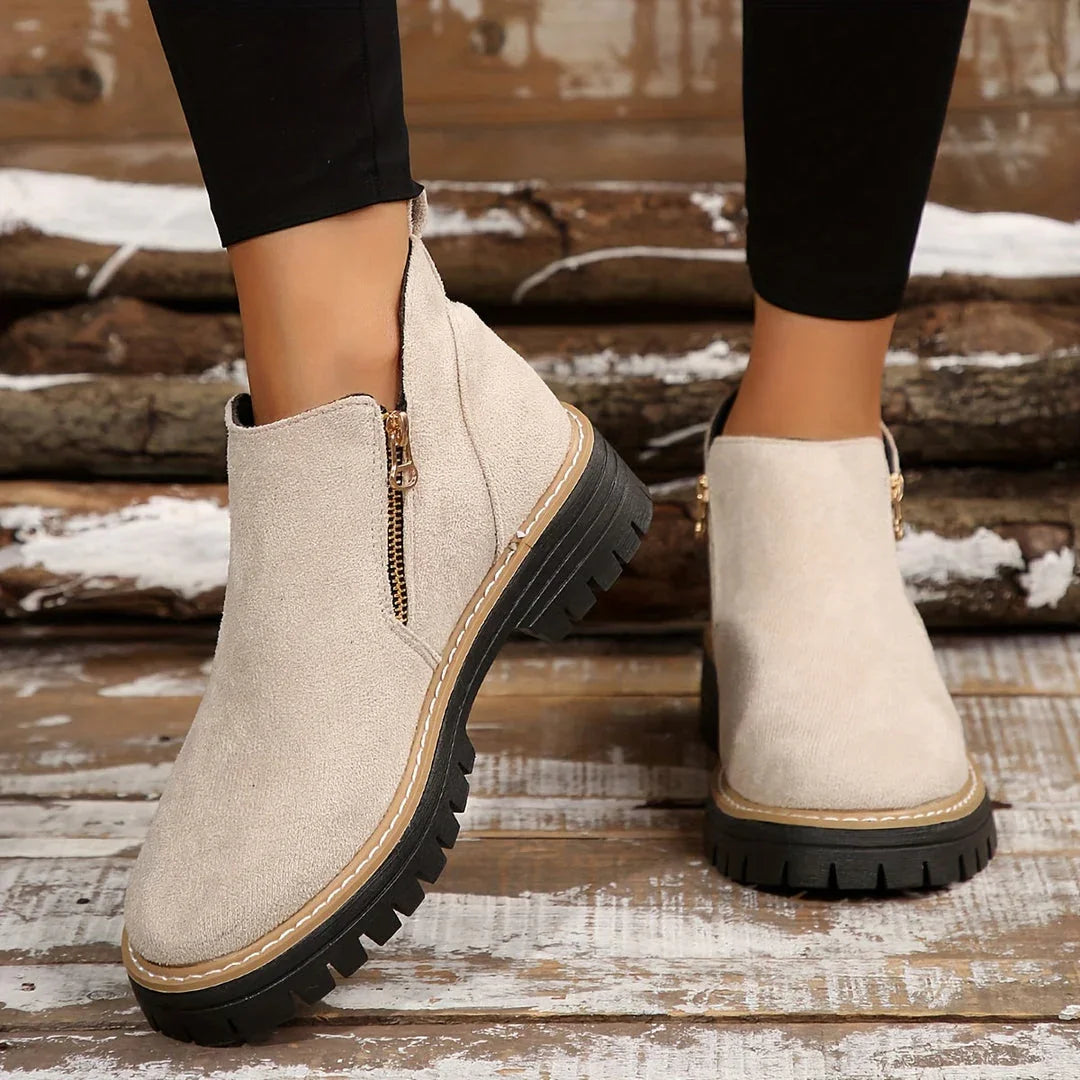 Beige suede ankle orthopedic boots with side zipper and black lug sole