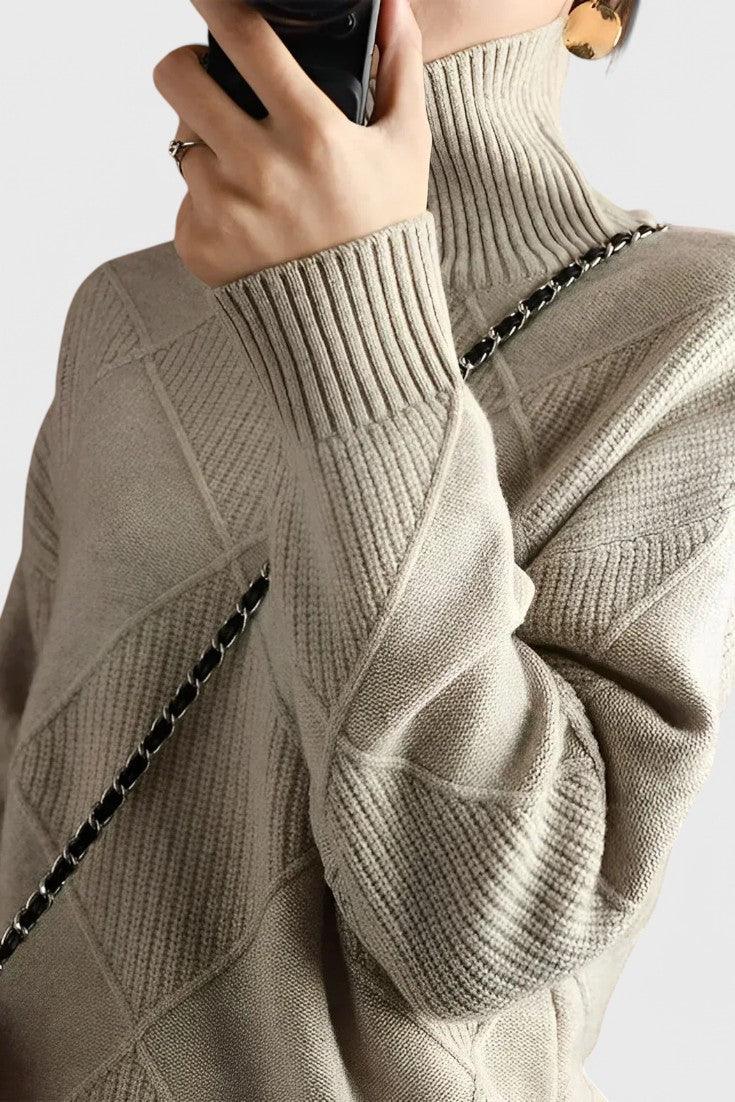Gray turtleneck sweater with ribbed collar, diamond knit panels, and long sleeves