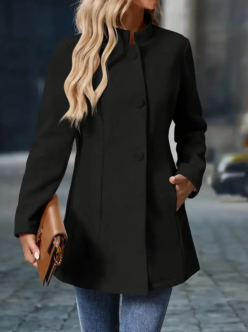 Black button-front long jacket with stand collar and long sleeves.