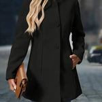 Black button-front long jacket with stand collar and long sleeves.