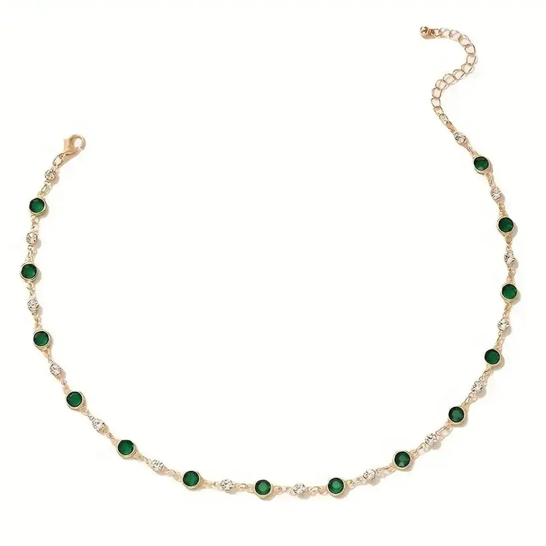 Gold-tone emerald station necklace featuring dark green oval stones in a row