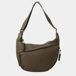 Olive anti-theft crossbody bag with curved hobo shape, adjustable strap, and side zipper pull.
