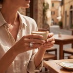 Silver elegant ring on a hand holding a coffee cup