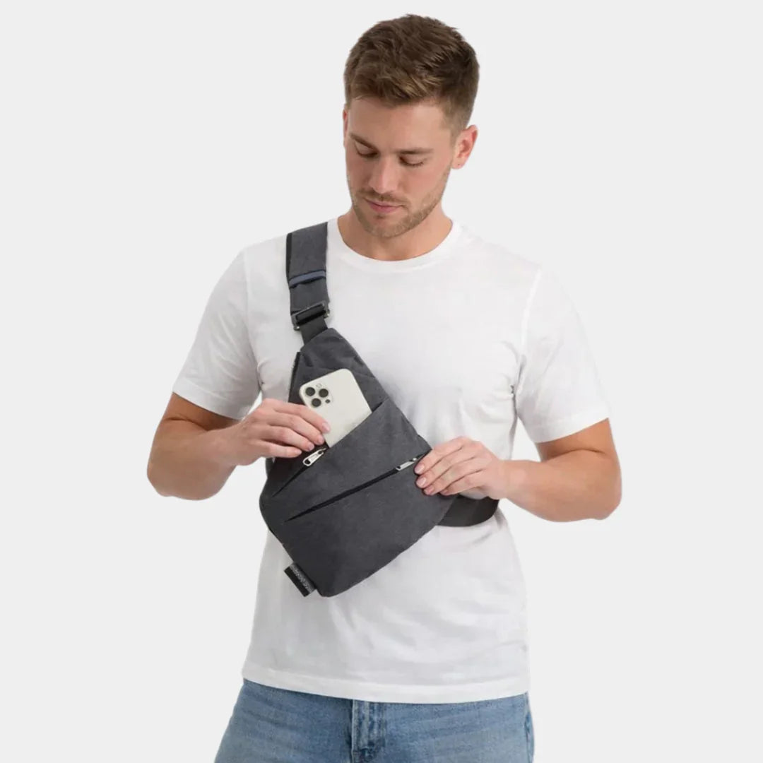 Dark gray anti-theft crossbody bag worn diagonally, front pocket visible