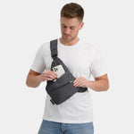 Dark gray anti-theft crossbody bag worn diagonally, front pocket visible