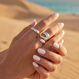 Silver open oval ring set with two stacked bands on hands, adjustable size