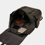 Leather backpack open at top, showing interior pockets and organizer compartments