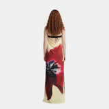 Back-view maxi dress with black strap trim and red/cream abstract floral print