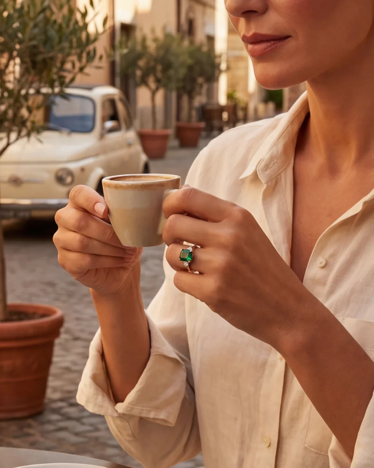 Gold ring with green gemstone worn on finger