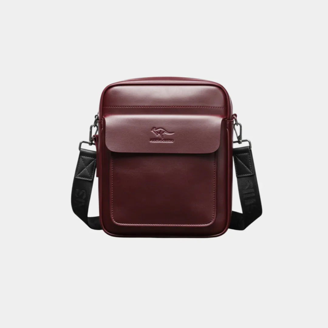 Wine red leather shoulder bag with flap, top handle, and adjustable crossbody strap