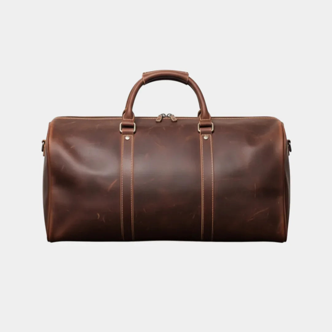 Dark brown leather travel bag with top handles, centered straps, and side zippers