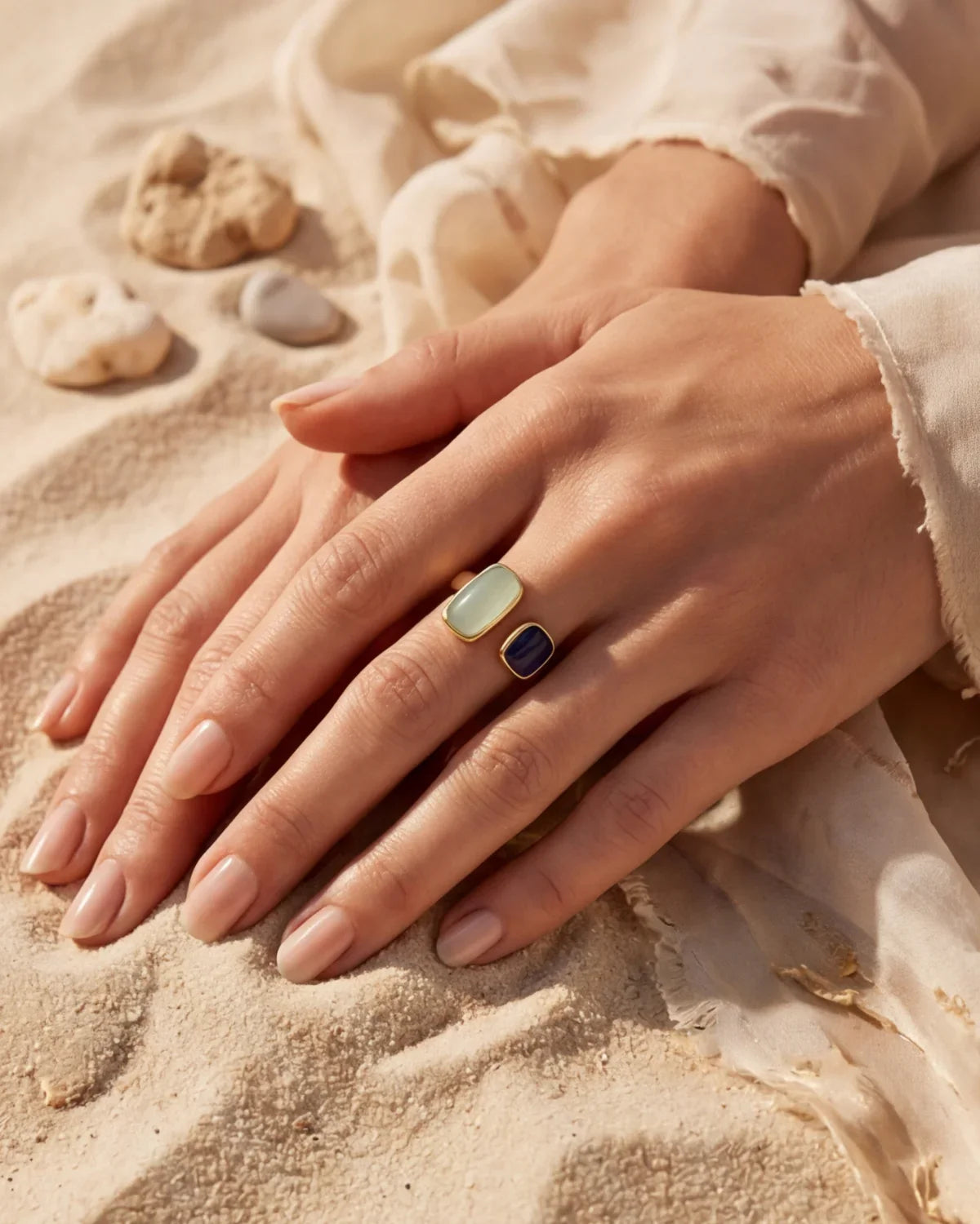 Gold-tone ring with oval mint top and dark square stone on adjustable band