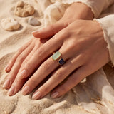 Gold-tone ring with oval mint top and dark square stone on adjustable band