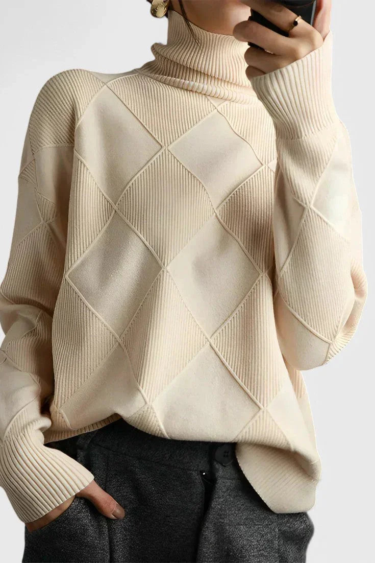 Ivory turtleneck sweater with ribbed cuffs and diamond knit pattern on sleeves