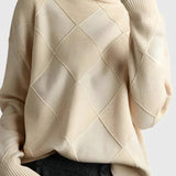 Ivory turtleneck sweater with ribbed cuffs and diamond knit pattern on sleeves