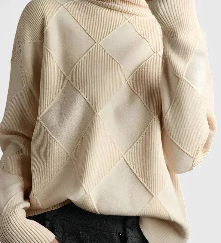 Ivory turtleneck sweater with ribbed cuffs and diamond knit pattern on sleeves