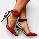 Wine red high heels with black ankle strap, striped side panels, and red rosette detail.