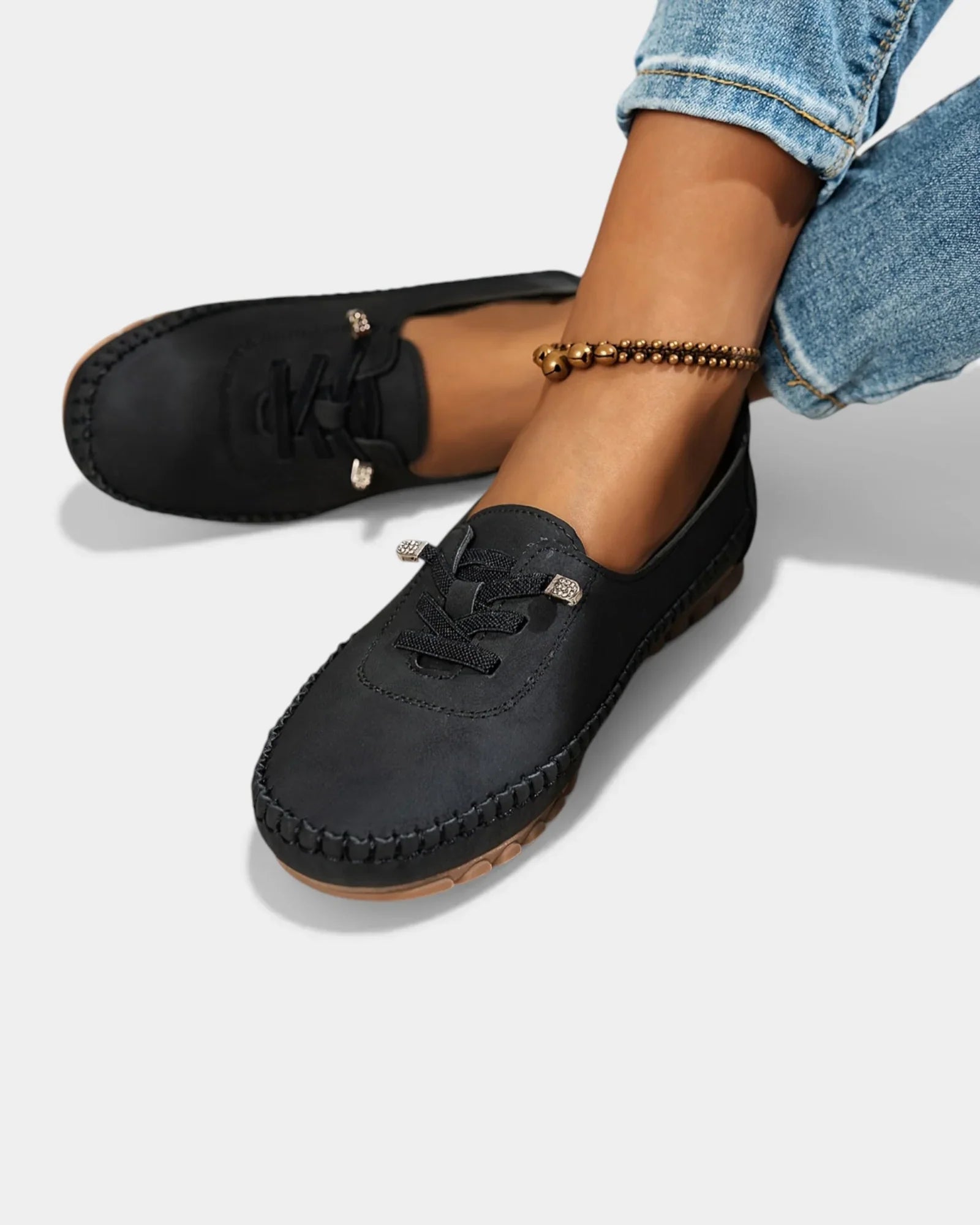 Black suede lace-up loafers with stitched moc toe and low profile sole.