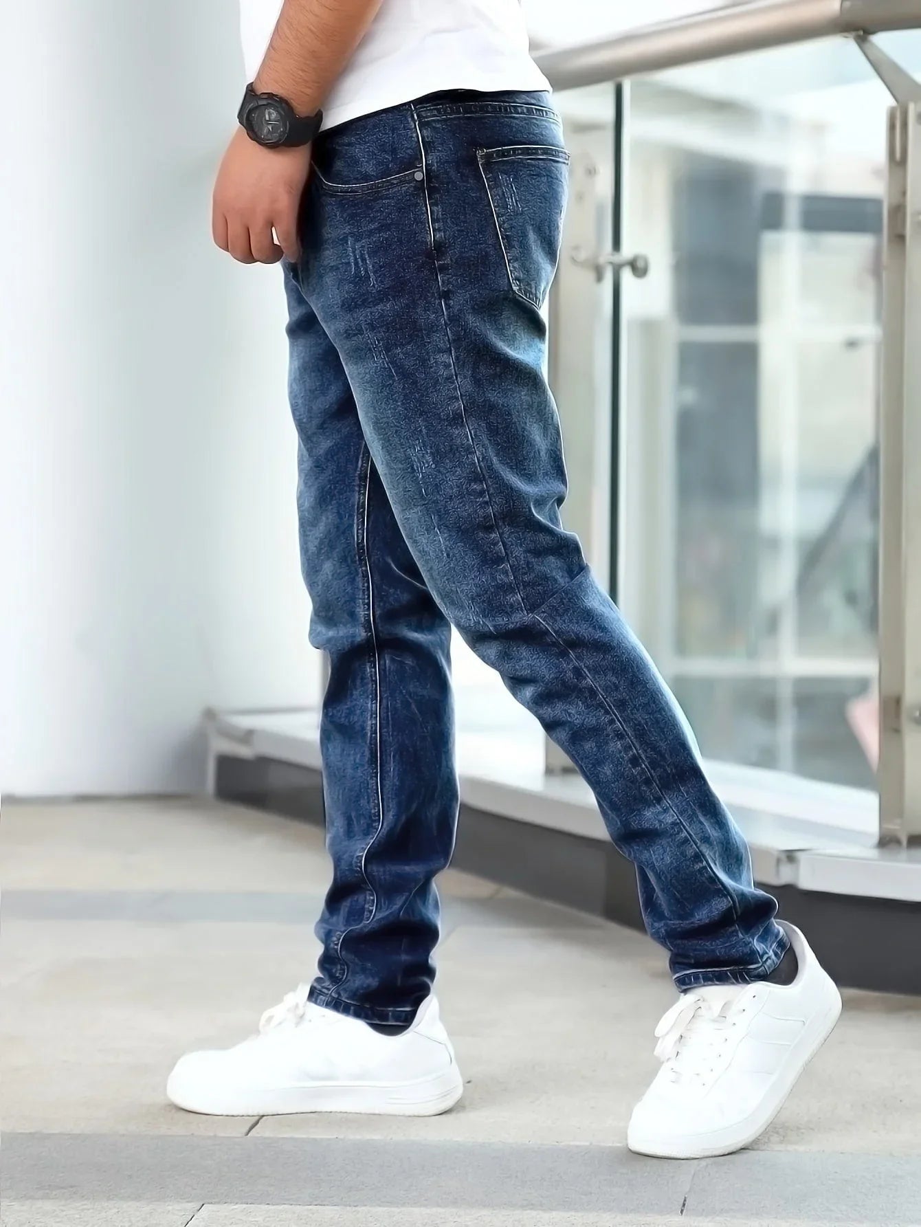 Dark blue casual stretch jeans with straight fit and visible pocket stitching