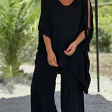 Black V-neck draped tunic with tie sleeves and wide-leg pants