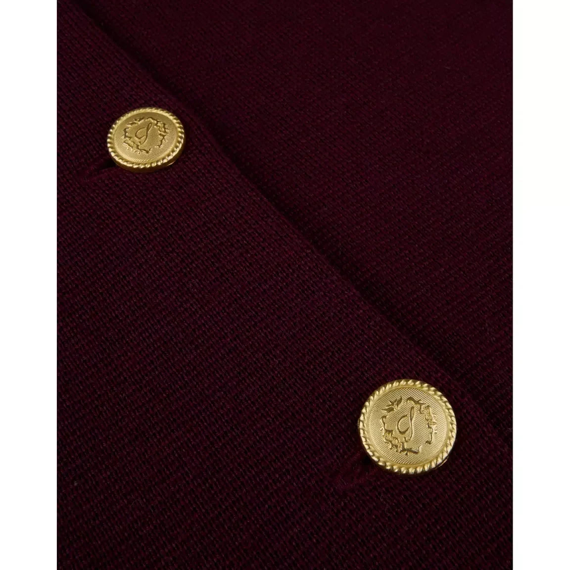 Burgundy merino wool cardigan close-up with gold button at seam