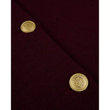 Burgundy merino wool cardigan close-up with gold button at seam
