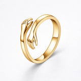 Gold embrace ring with open top, sculpted wave design