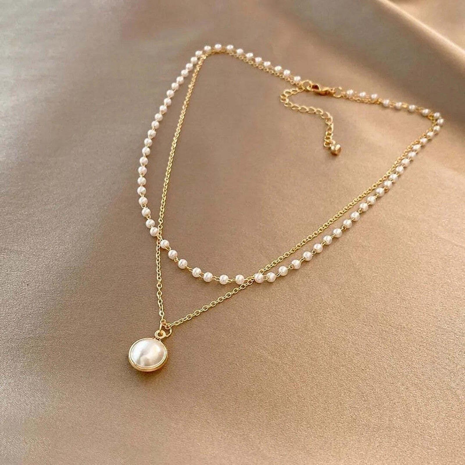 Gold luster pearl necklace with round pearl pendant and layered bead chain