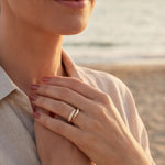 Gold adjustable ring with a curved band and pave-style accent