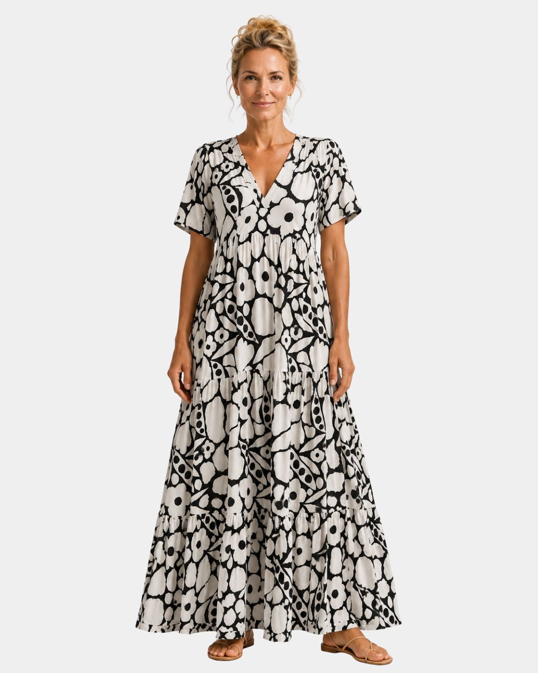 Black and white floral maxi dress with V-neck, short sleeves, and tiered skirt