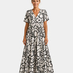 Black and white floral maxi dress with V-neck, short sleeves, and tiered skirt