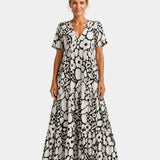 Black and white floral maxi dress with V-neck, short sleeves, and tiered skirt