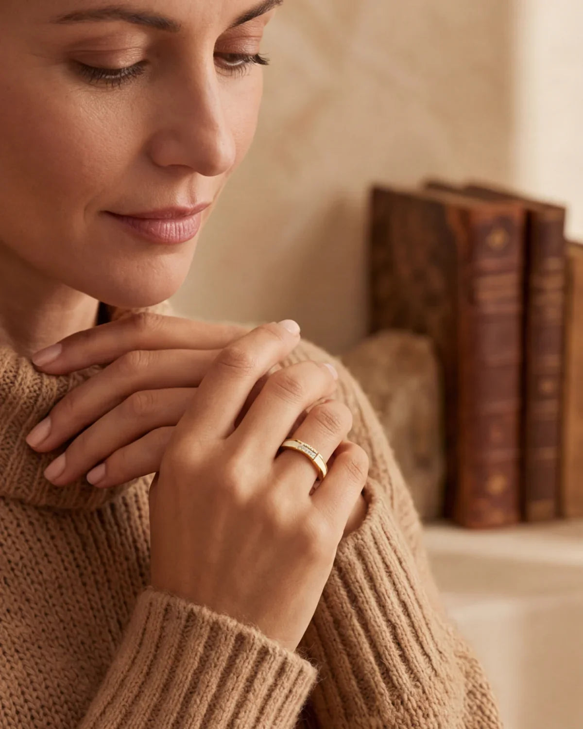 Gold ring with clear stone band, worn on a woman’s finger