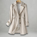 Light beige spring trench coat with notched lapels, flap pockets, and button front