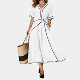 White V-neck spring dress with short sleeves, waist knot, and A-line midi skirt