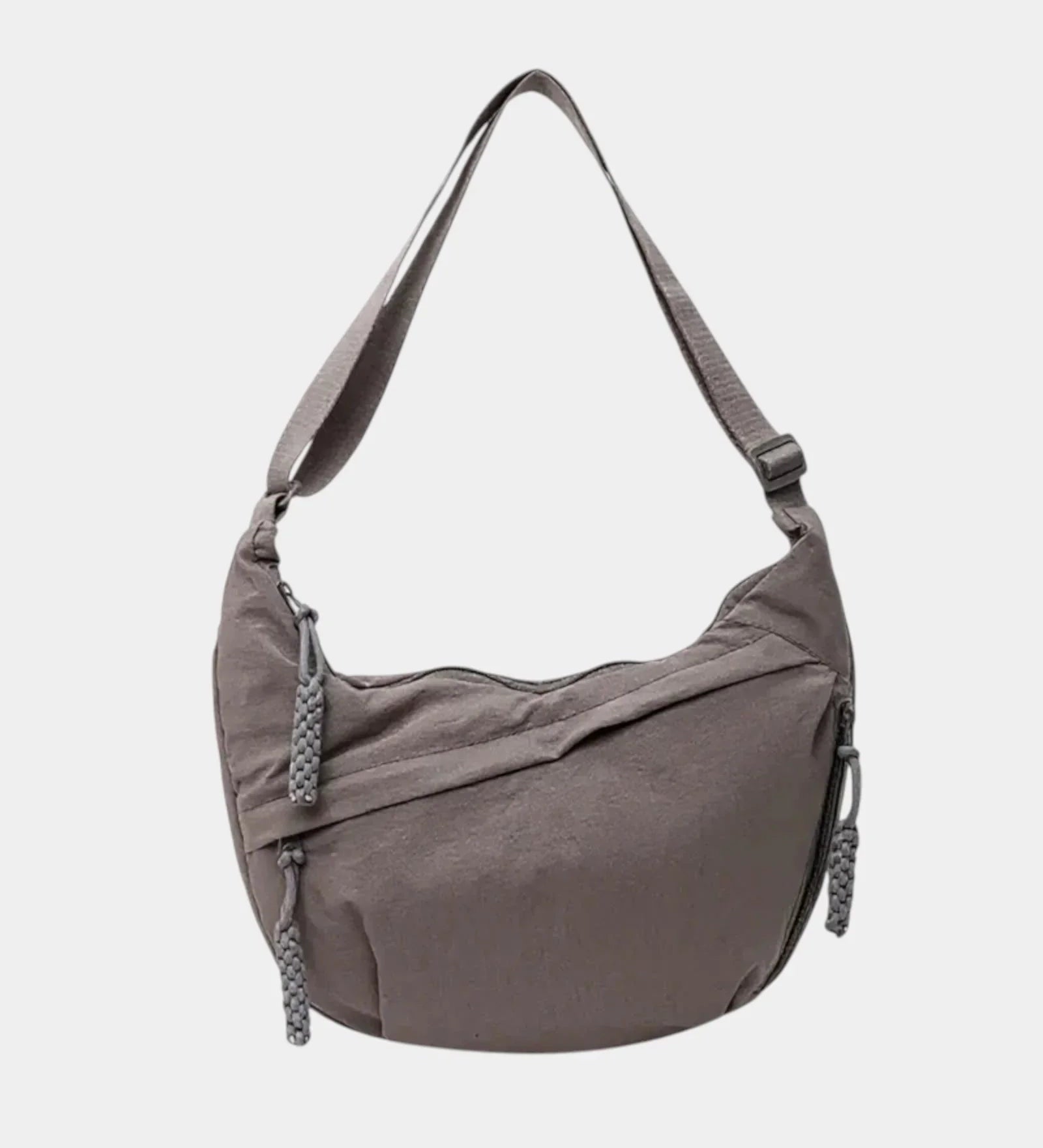 Gray anti-theft crossbody bag with curved hobo shape, adjustable strap, and zipper pull.