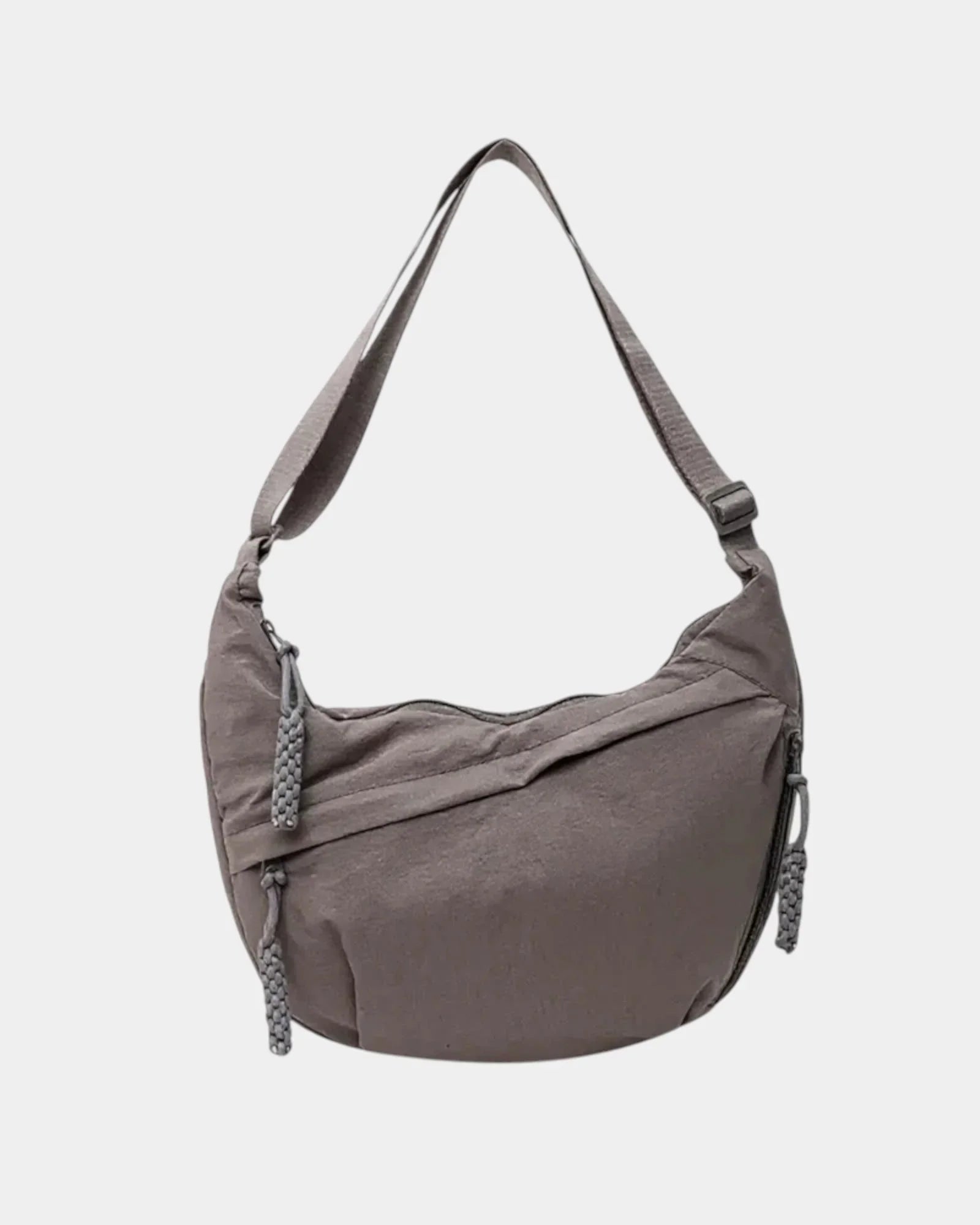 Gray anti-theft crossbody bag with curved hobo shape, adjustable strap, and zipper pull.