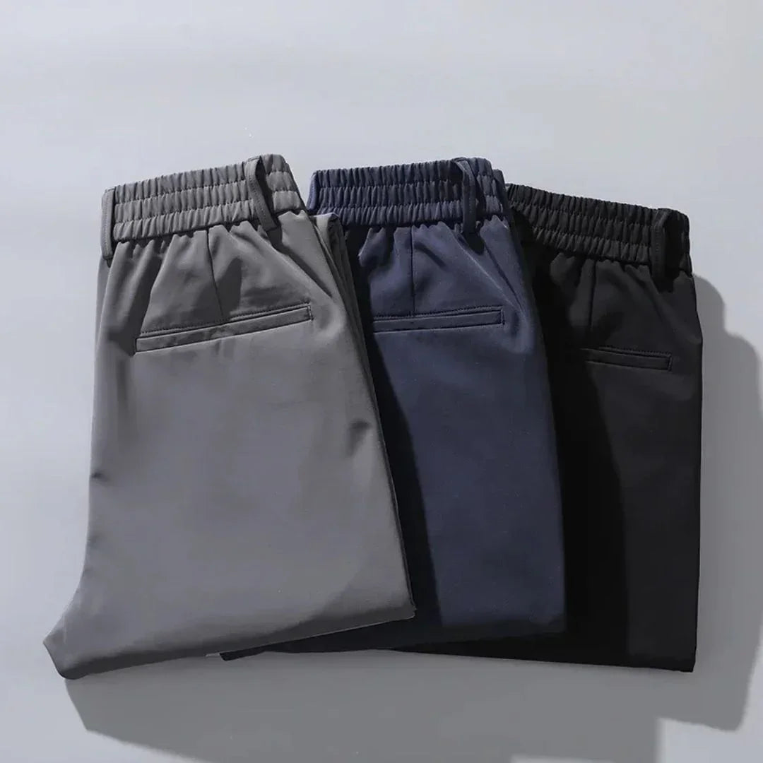 Pack of three men's dress pants: gray, navy, and black with elastic waist