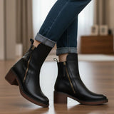Black leather ankle boots with side zipper and tassel, block heel on floor