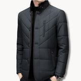 Dark quilted winter jacket with stand collar, front snaps, and side chest pocket