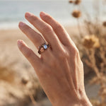 Bronze branch-effect ring with oval opalescent blue cabochon and leafy setting