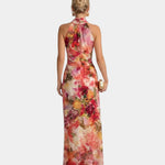 Back view of floral halter maxi dress with halter neck and long skirt