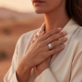 Silver ring with rectangular clear stone worn on a woman's hand