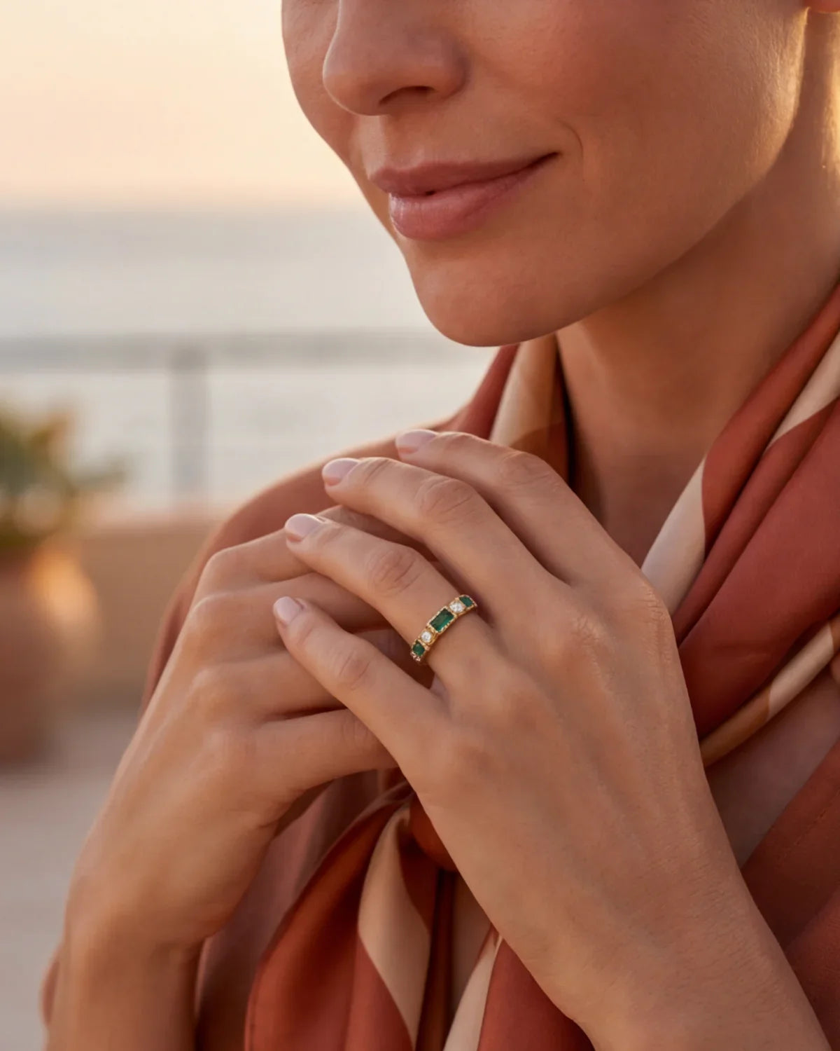 Gold ring with green rectangular stones separated by small clear accents